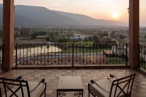 a balcony with a view of the mountains at Toscana Valley Town Square Suites in Mu Si