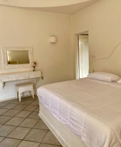 a bedroom with a bed and a dresser with a mirror at Casa Blanca in Santa Cruz Huatulco +10 photos