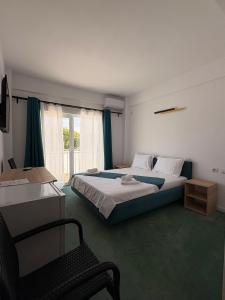 En eller flere senge i et værelse på Sunrise Boutique