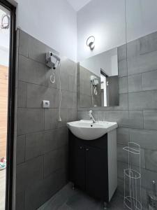 a bathroom with a sink and a mirror at Sunrise Boutique in Costinesti