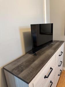a flat screen tv sitting on top of a dresser at Classic king and queen suite in Schenectady +12 photos