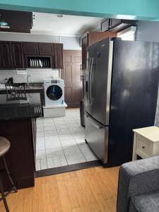 a kitchen with a stainless steel refrigerator at Classic king and queen suite in Schenectady