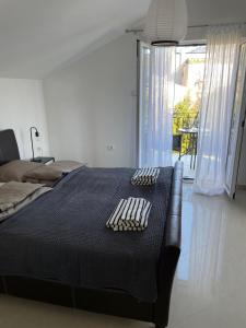 a bedroom with a bed with a black comforter at Villa Verde Oliva in Kamenari