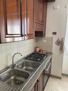 a kitchen with a sink and a stove at Casa cozy e luminosa - Tiburtina in Rome