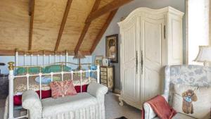 a bedroom with a bed and a couch and a chair at Stunning Cliff Face and Valley Views in Katoomba