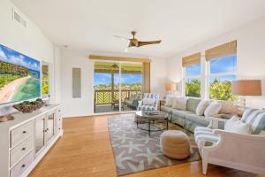 a living room with a couch and a table at Pili Mai 8K in Koloa