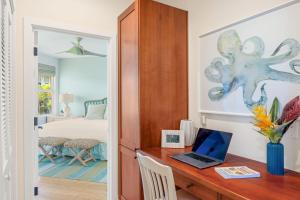 a room with a desk with a laptop on it at Pili Mai 8K in Koloa +38 photos