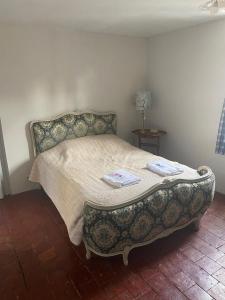 a bedroom with a bed with a benchituresigunigunigunigunigun at Maison Belle Croix in Châtillon-Coligny +11 photos