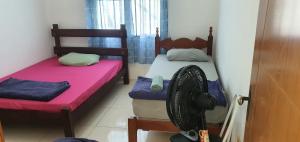 Zimmer mit 2 Etagenbetten und einem Ventilator in der Unterkunft casa dois quartos completa em saquarema, barra nova in Saquarema