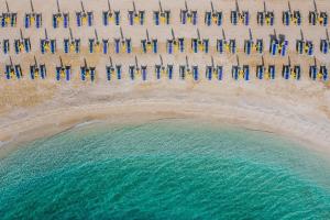 an aerial view of a beach with a group of umbrellas at Apartments with parking space Selce, Crikvenica - 24450 in Selce