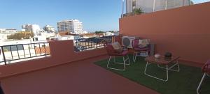 a balcony with chairs and a table on a balcony at Faro Station Eleven Guest House in Faro