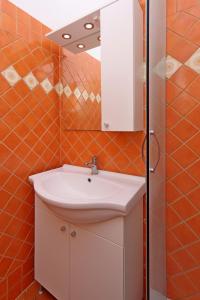 a bathroom with a white sink and a mirror at Apartments with parking space Selce, Crikvenica - 24450 in Selce +14 photos