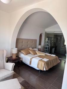 a bedroom with a large bed and a chair at Casa Farah Villa Marbella Golden Mile Coral Beach behind ALDI in Marbella +52 photos