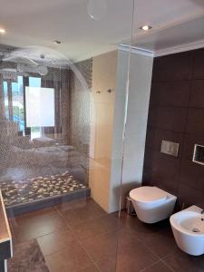 a bathroom with a shower and a toilet and a sink at Casa Farah Villa Marbella Golden Mile Coral Beach behind ALDI in Marbella