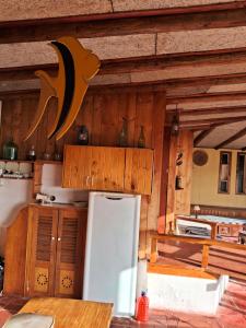 a kitchen with a white refrigerator and wooden cabinets at Una vista impresionante in Mirasol