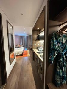 a room with a bathroom and a bedroom with a bed at The Raclay Mandala Cham Bay Mui Ne - Phan Thiet in Phan Thiet