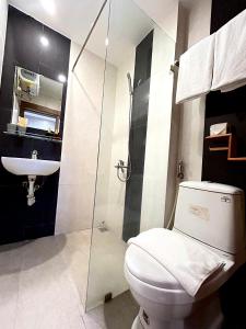 a bathroom with a toilet and a sink at BeSea Hotel in Danang