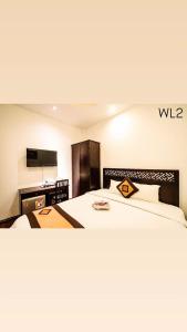 a hotel room with a bed and a desk at Wild LoTus Ha Noi in Hanoi