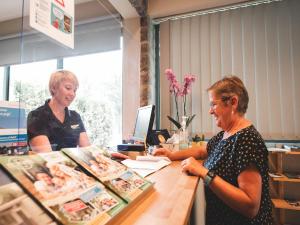 two women standing at a counter in a store at Chalet in Olloy-sur-Viroin with Patio in Olloy-sur-Viroin
