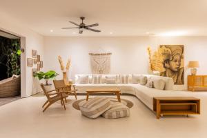 a living room with a couch and a table at IBU The Sanctuary by OXO in Ubud