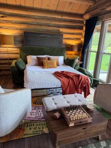 a bedroom with a bed and a chessboard on a rug at A Novel Stay 3 bed 2 bath log cabin in Shelbyville, IL in Shelbyville