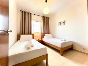 a hotel room with two beds and a window at Coastal Elegance - Bella Vista in Cabo Negro