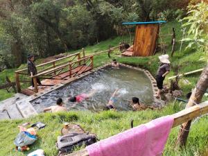 a group of people in a pool of water at Las Bromelias in Coconuco