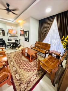 a living room with a couch and a table at Siti homestay kota bharu in Kota Bharu