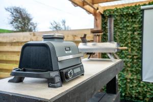 a small television sitting on a table next to a grill at Clyde Croft - (Luxury Cabin) in Portpatrick