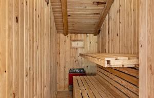 a wooden interior of a sauna with a bench at Holiday Home Hedevej Xii Denmk in Ho