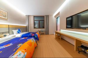 TV a/nebo společenská místnost v ubytování Guyuan Golden Garden Hotel + 26 fotografií