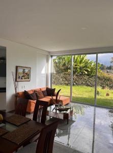 a living room with a couch and a table at Encenillos del Manantial in Circasia