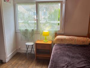 a bedroom with a bed and a window with a lamp at Maison de ville au Croisic avec WIFI et animaux admis - 4 personnes - FR-1-843-6 in Le Croisic +2 photos
