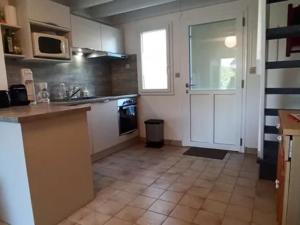 a kitchen with a counter and a door to a kitchen at Maison proche plages Le Croisic, parking inclus - FR-1-843-14 in Le Croisic +3 photos