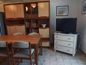 a dining room with a table and a television at Maison proche plages Le Croisic, parking inclus - FR-1-843-14 in Le Croisic