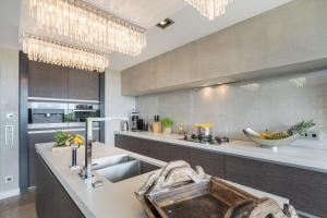 a kitchen with a sink and a counter top at Lands-End in Hörnum