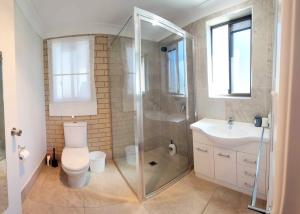 a bathroom with a shower and a toilet and a sink at Big family holiday by the Buddina beach in Buddina