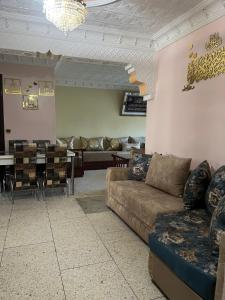 a living room with a couch and a dining room at Apparemment al baraka in Tangier
