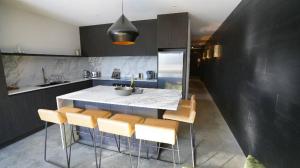 a kitchen with a table and some chairs in it at Konayuki Apartment 8 in Falls Creek
