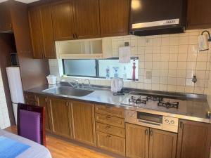 a kitchen with a sink and a stove at 山海a in Shizuoka +6 photos