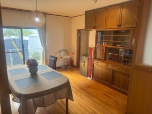 a kitchen with a table with a vase on it at 山海a in Shizuoka