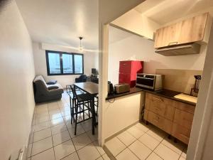 a small kitchen with a table and a dining room at Salon de Provence in Salon-de-Provence