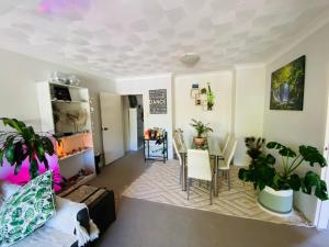 a living room with a table and chairs at Nico's unit Two bedrooms shared in Sydney +6 photos