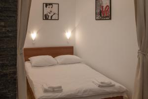 a small bed in a room with two white pillows at Apartments Lana 2 in Split