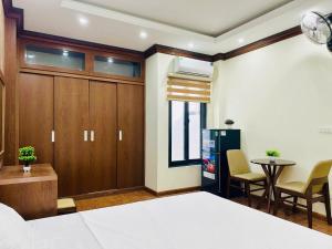 a bedroom with a bed and a table and chairs at Lightmoon- 196 Phú Diễn in Văn Trì
