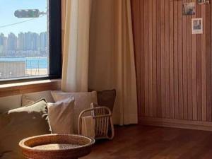 a living room with a couch and a window at Busan Gwangan 273 in Millak-tong