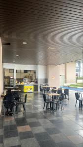 a dining room with tables and chairs and a cafeteria at Aisyah Mutiara Bali Residence Melaka in Malacca +26 photos