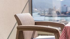 a wicker chair sitting on top of a balcony at Tongyeong Pension Present Pension in Tongyeong