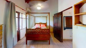 a bedroom with a bed with a mirror on it at Rio Copey 2 near the beach in Jaco in Jacó +36 photos