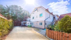 a house on a street in a residential neighborhood at Gangneung Booyeon Pension in Gangneung